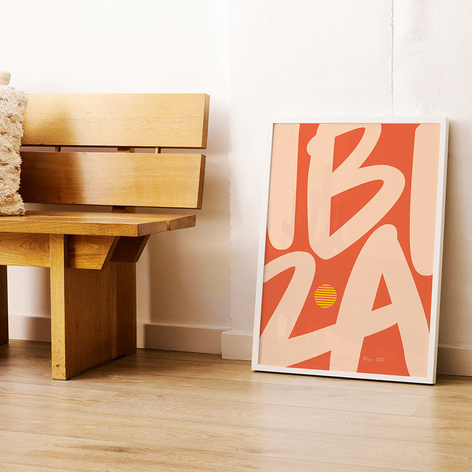 Framed minimal style Ibiza typography print with the word Ibiza in soft orange and sandy colours. 