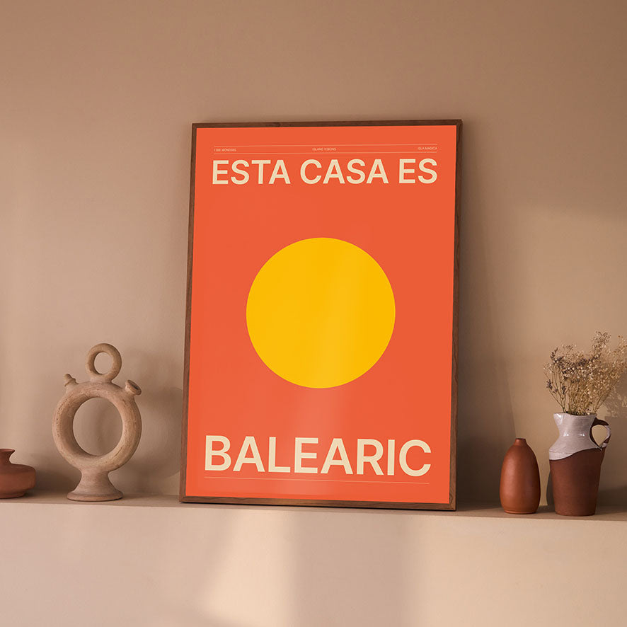 Framed Minimal style Ibiza typography art print which says Esta Casa Es Balearic / This House is Balearic in cream writing on a rich orange background with warm yellow sun.