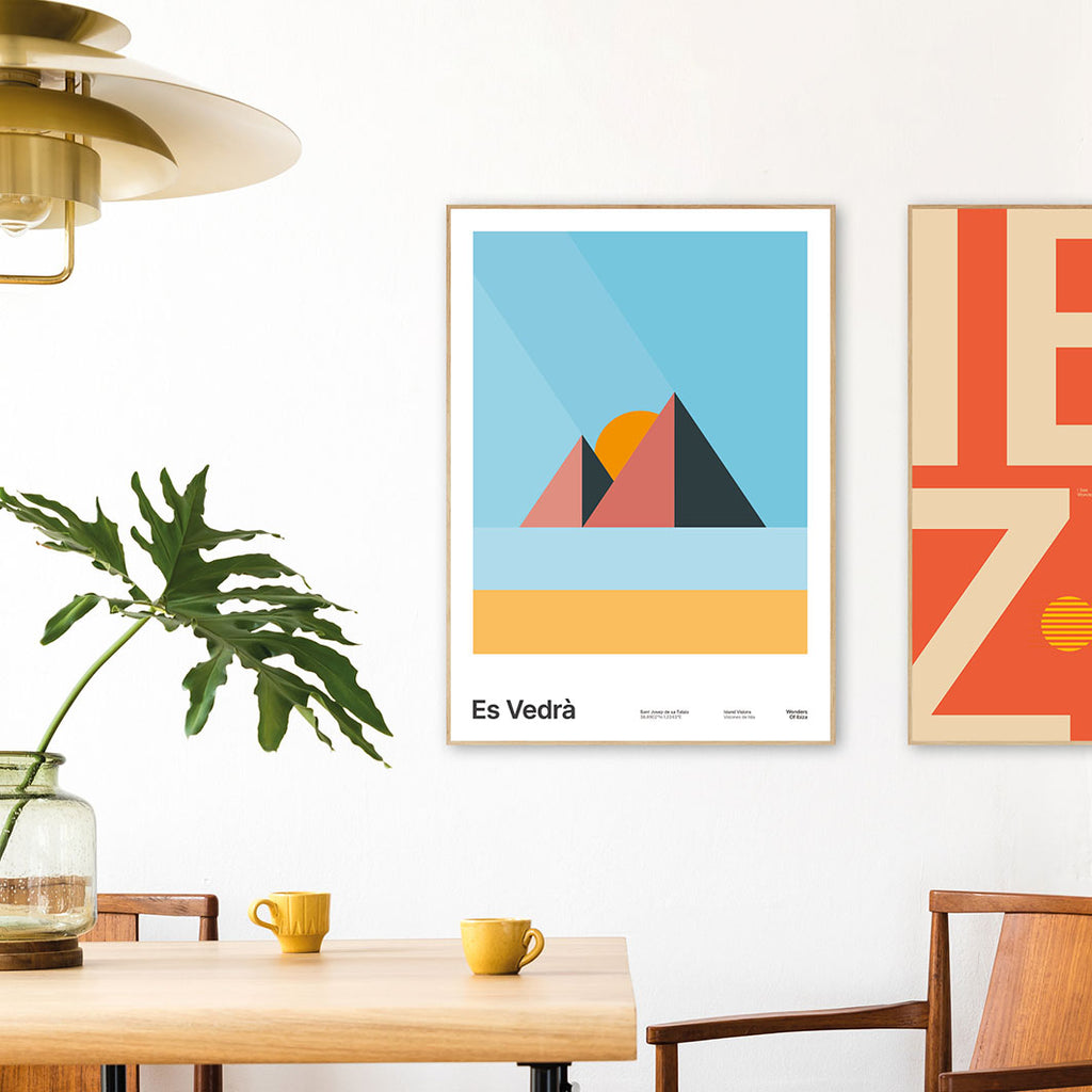 Framed Minimal style graphic design Ibiza art print of Es Vedra, Ibiza represented as pink pyramids with golden sand on a blue sky background.