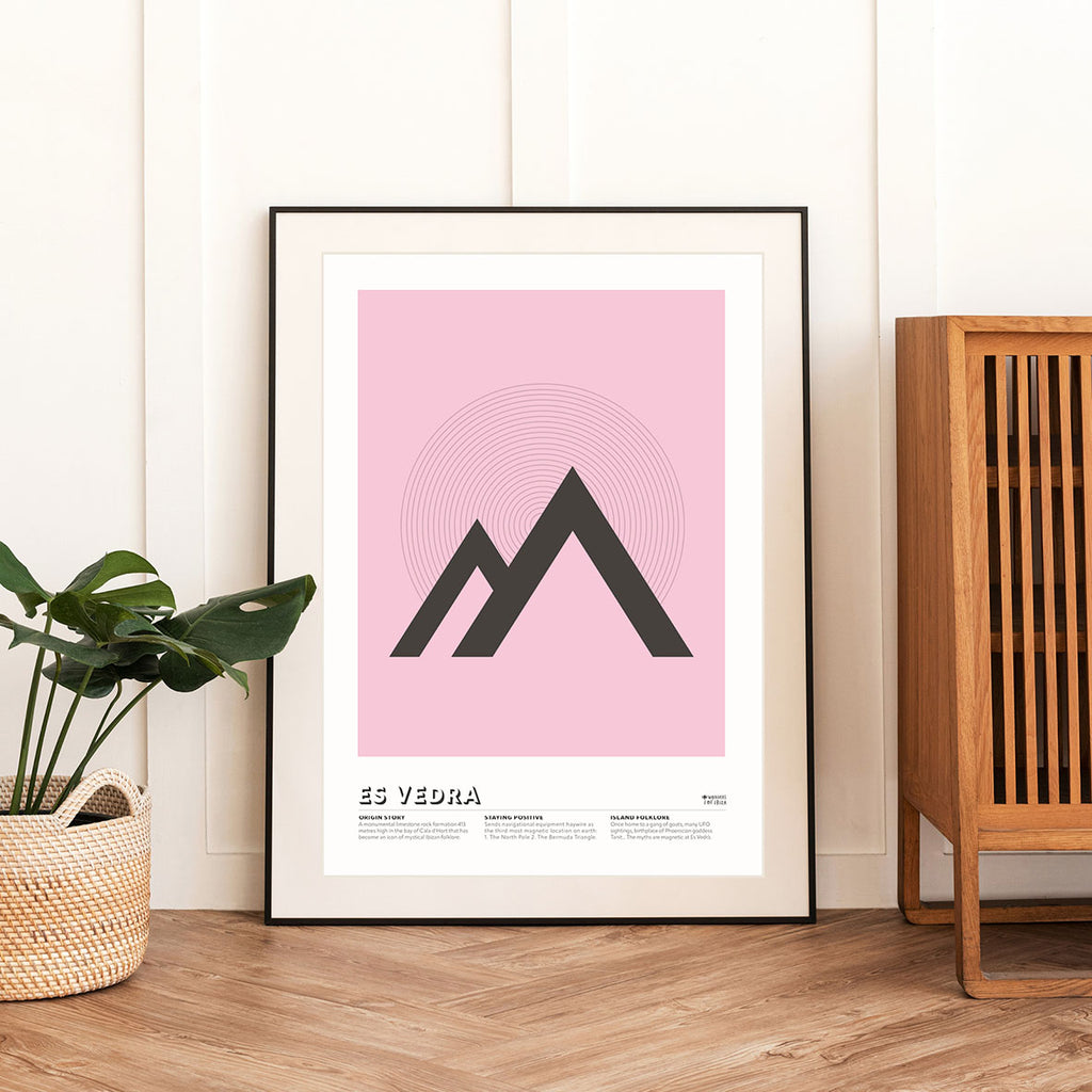 framed Minimal style graphic design Ibiza art print of Es Vedra, Ibiza represented as triangles on a pink background.